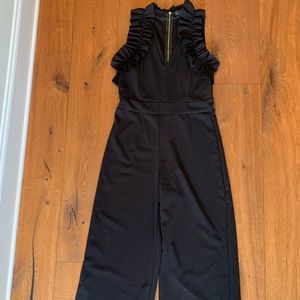 Black jumpsuit with ruffle top and wide legs